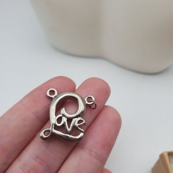 Love silver toned necklace pendant